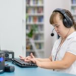 Young,Girl,With,Syndrome,Down,Uses,Computer,At,Library.,Education
